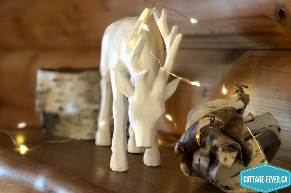 white deer, birch bark, mantel, string lights