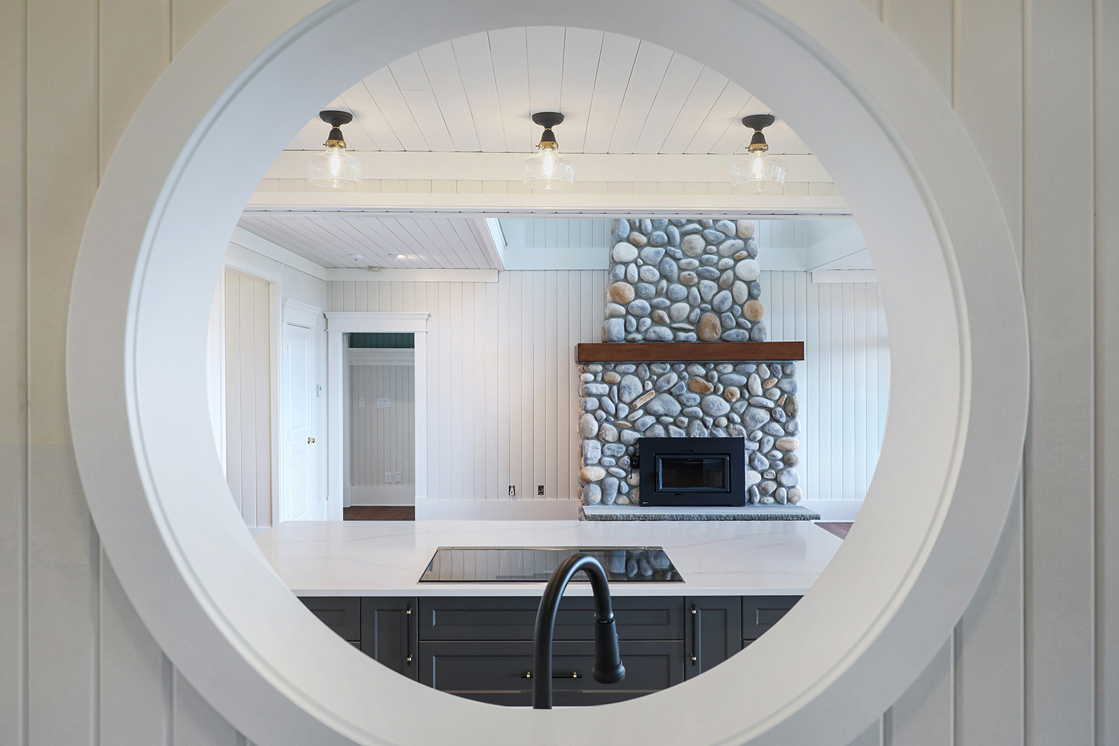 Round window from mudroom looking into kitchen.  Photo credit: LSP Media